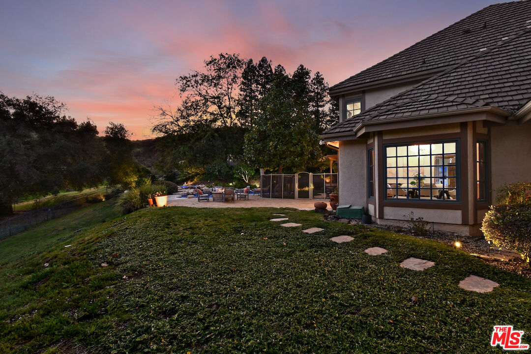 2317 Sierra Creek Road Agoura Hills, CA 91301 - Photo 64 of 73 a view of a house with a backyard and garden