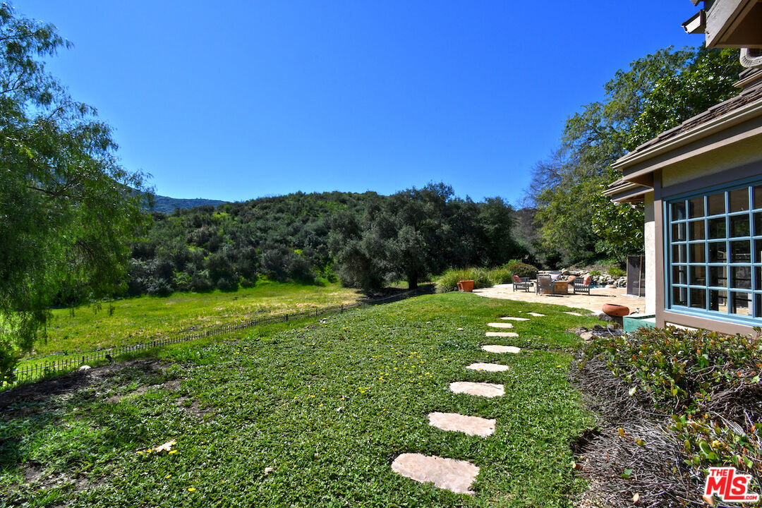 2317 Sierra Creek Road Agoura Hills, CA 91301 - Photo 65 of 73 a backyard of a house with lots of green space