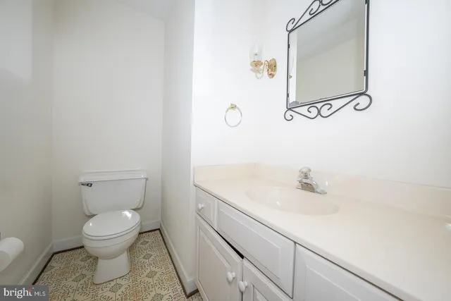 a bathroom with a toilet a sink and mirror