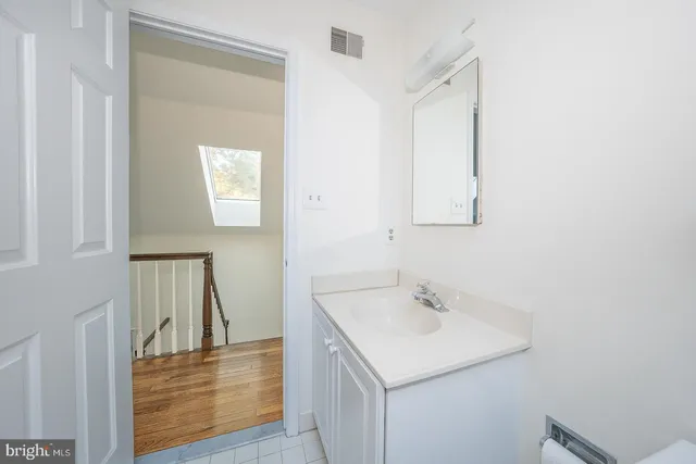 a bathroom with a sink a mirror and vanity