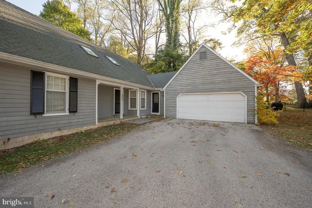 a view of a house with a yard and garage