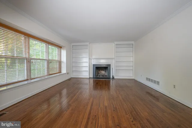 wooden floor fireplace and natural light in room