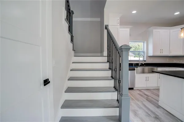 a view of entryway and hall with wooden floor