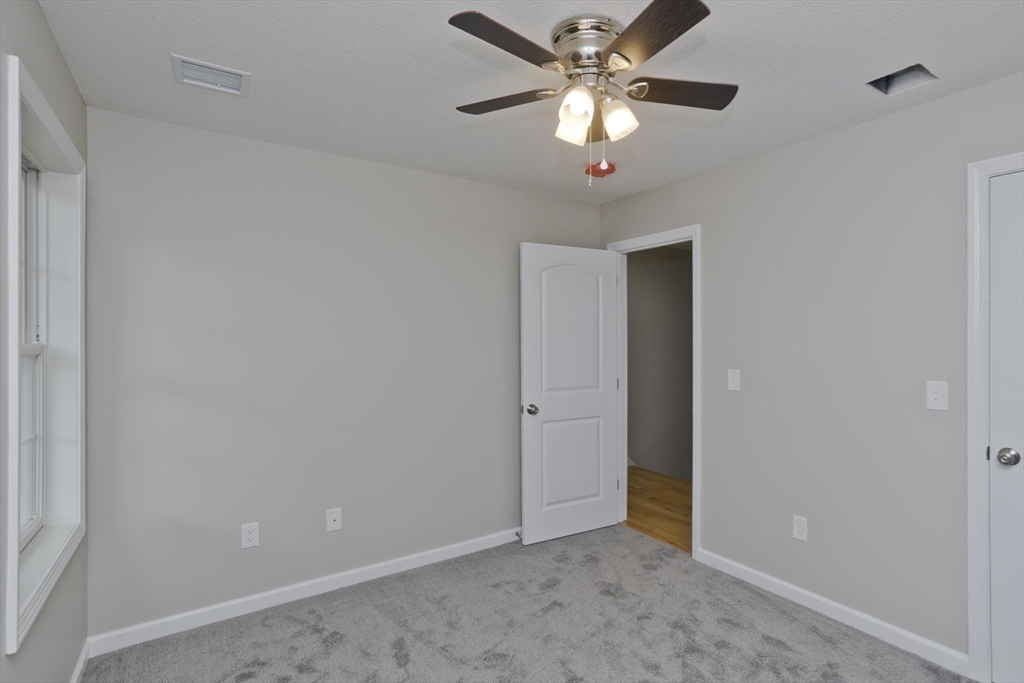 34 Chilson Street Springfield, MA 01118 - Photo 14 of 23 a view of an empty room with a fan