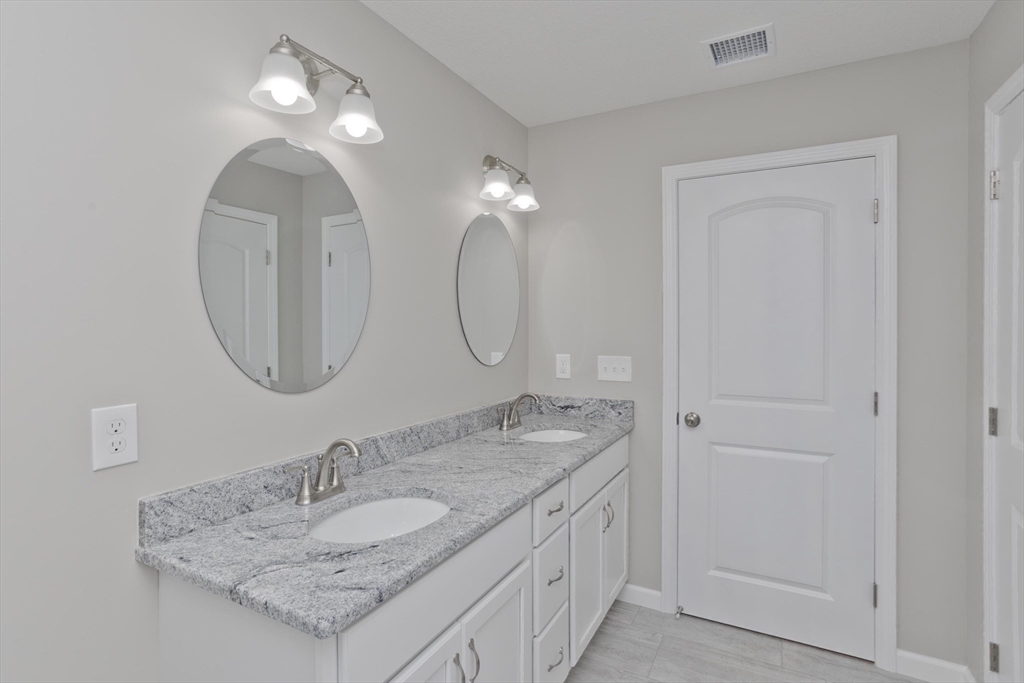 34 Chilson Street Springfield, MA 01118 - Photo 18 of 23 a bathroom with a granite countertop double vanity sinks and a mirror