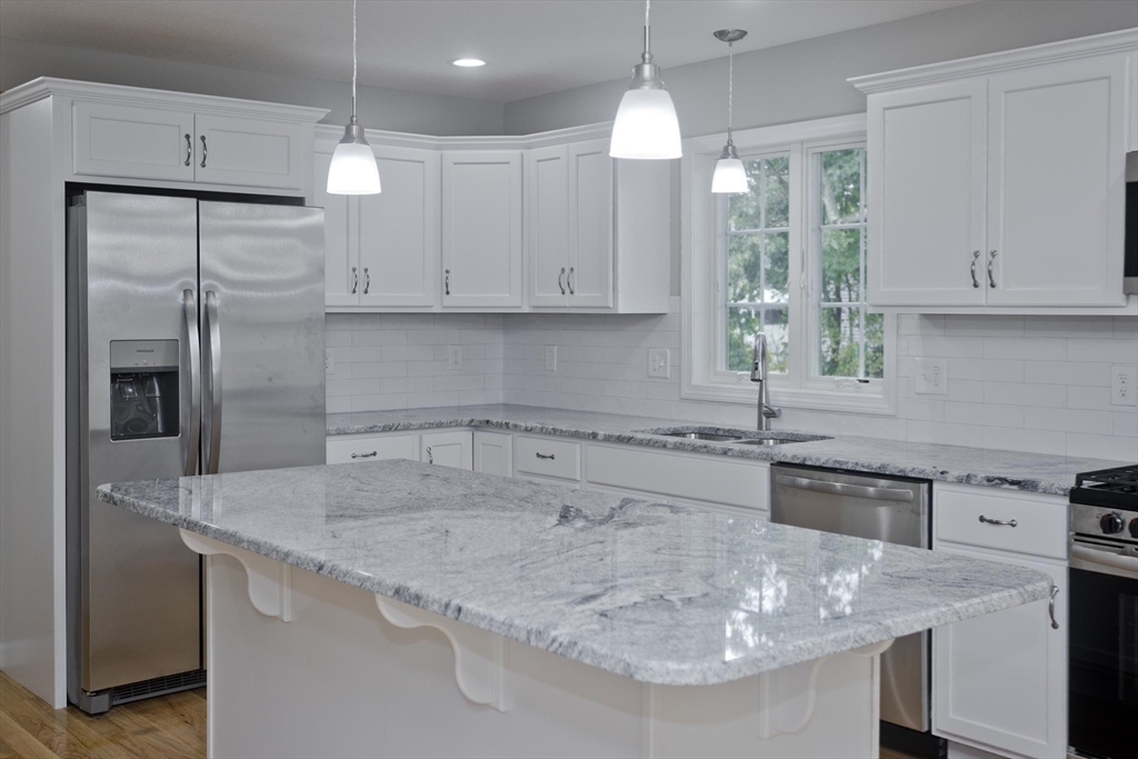34 Chilson Street Springfield, MA 01118 - Photo 5 of 23 a kitchen with stainless steel appliances granite countertop a sink a stove and a refrigerator