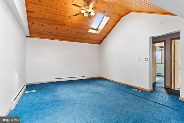 a large kitchen with stainless steel appliances a large counter top a stove a sink dishwasher and microwave with wooden floor