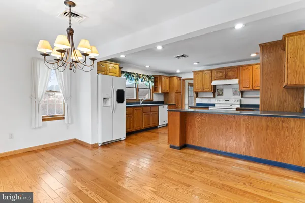 a view of kitchen with sink microwave and refrigerator