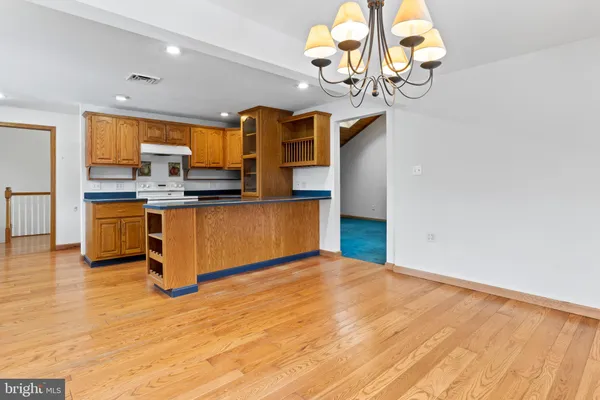a kitchen that has a lot of fruit on it and wooden floor