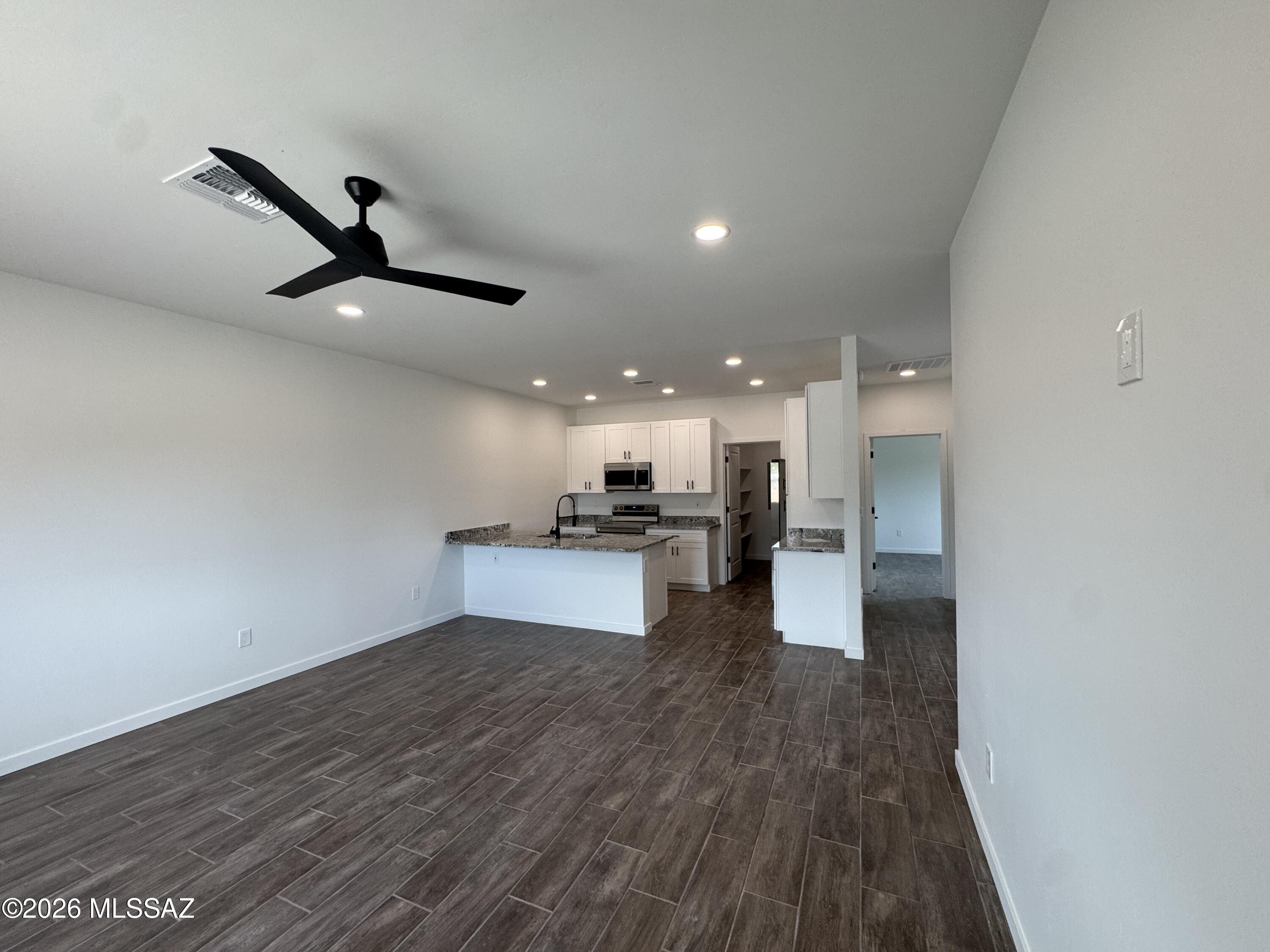 2122 North Ralph Avenue, Unit 1 Tucson, AZ 85712 - Photo 2 of 10 a living room with stainless steel appliances kitchen island hardwood floor and a sink