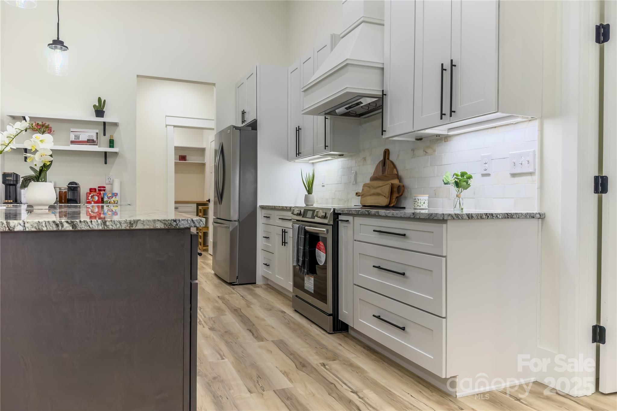 409 19th Ave Circle Northwest, Unit 12 Hickory, NC 28601 - Photo 17 of 46 a kitchen with stainless steel appliances a refrigerator and cabinets