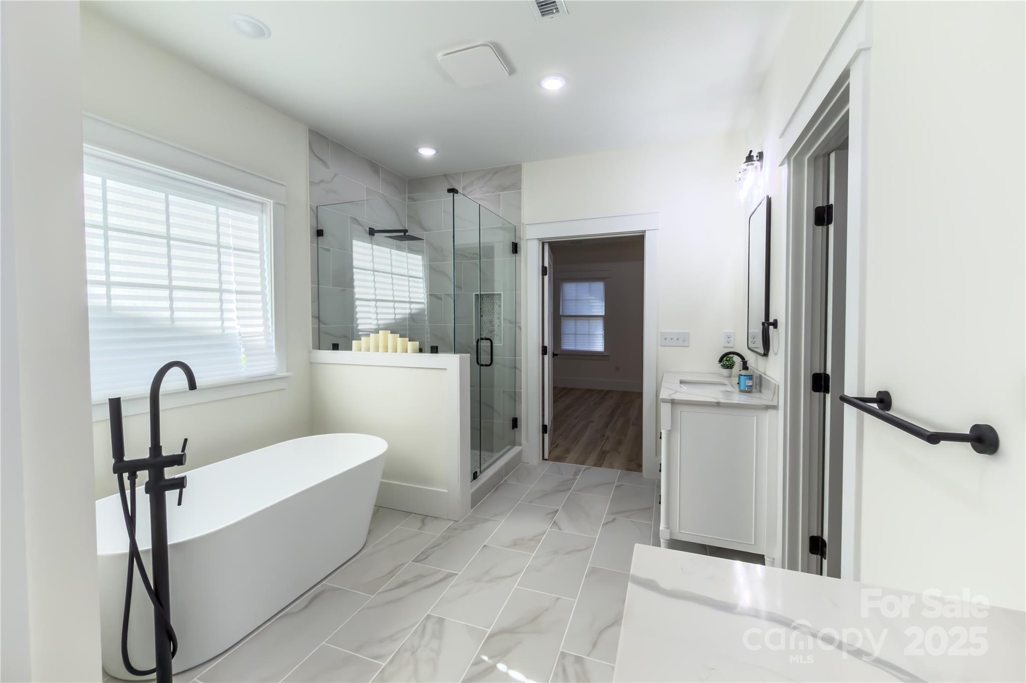409 19th Ave Circle Northwest, Unit 12 Hickory, NC 28601 - Photo 23 of 46 a bathroom with a tub sink shower and mirror