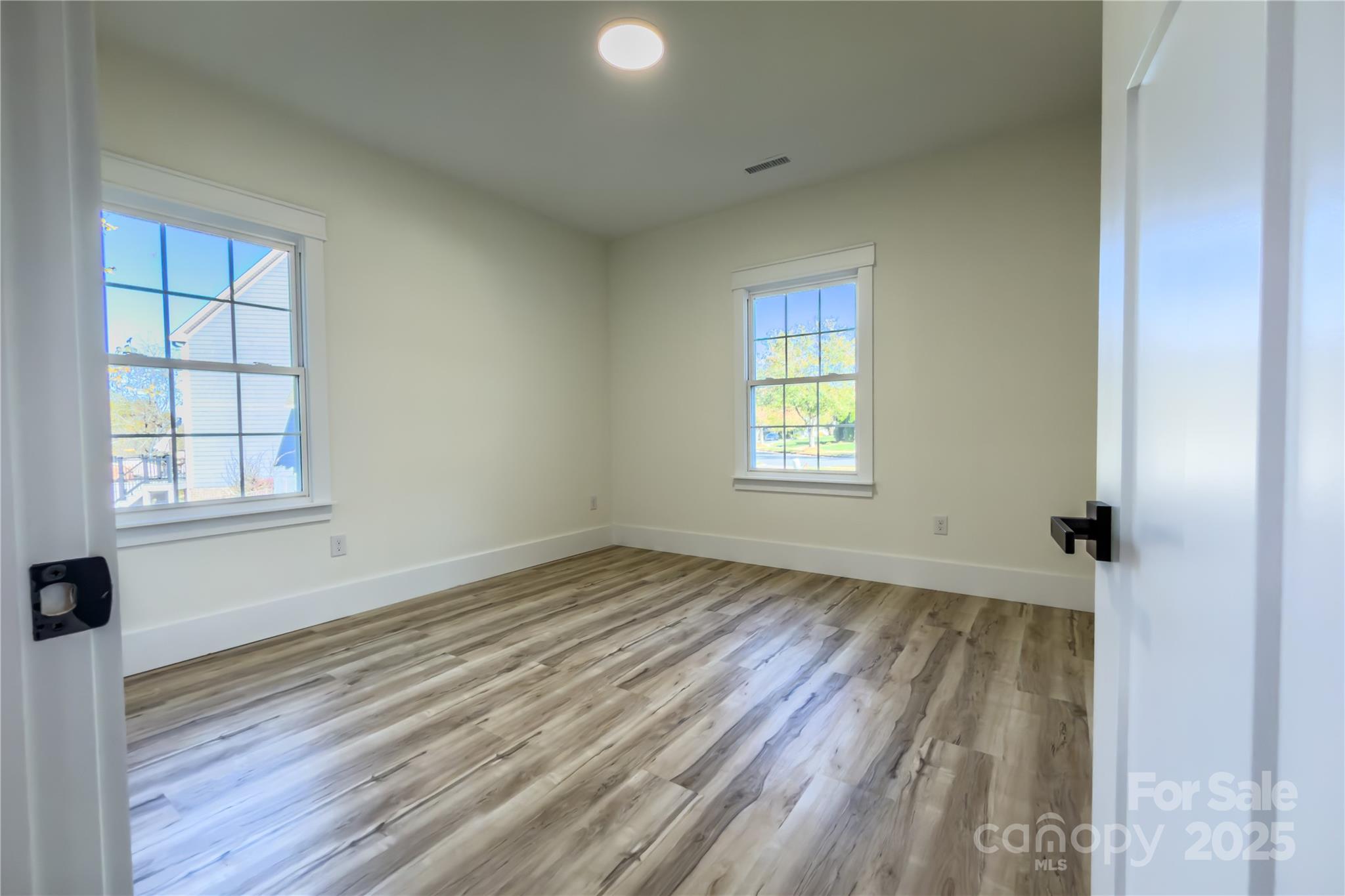 409 19th Ave Circle Northwest, Unit 12 Hickory, NC 28601 - Photo 27 of 46 an empty room with wooden floor and windows
