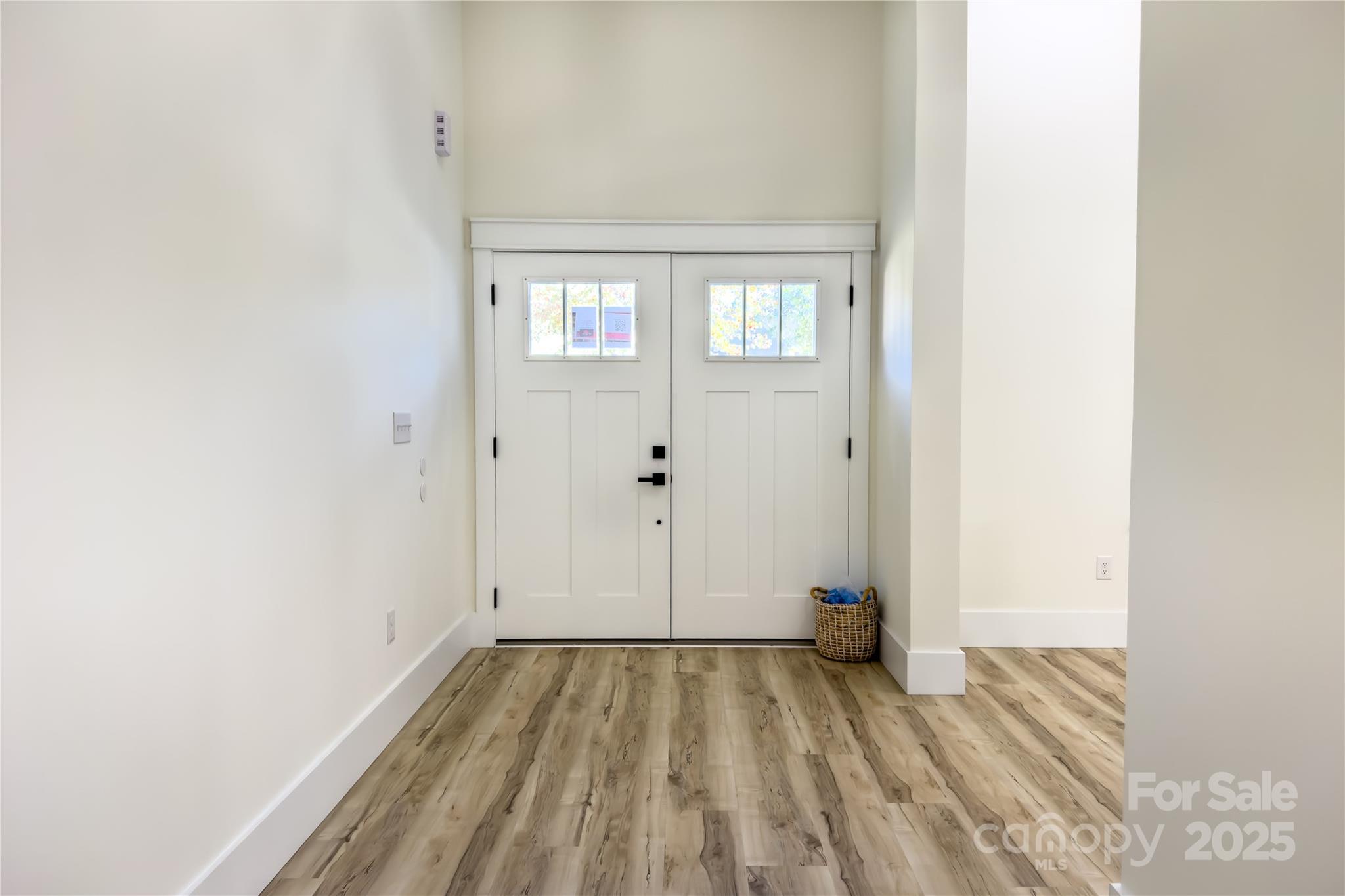 409 19th Ave Circle Northwest, Unit 12 Hickory, NC 28601 - Photo 3 of 46 an empty room with wooden floor and windows