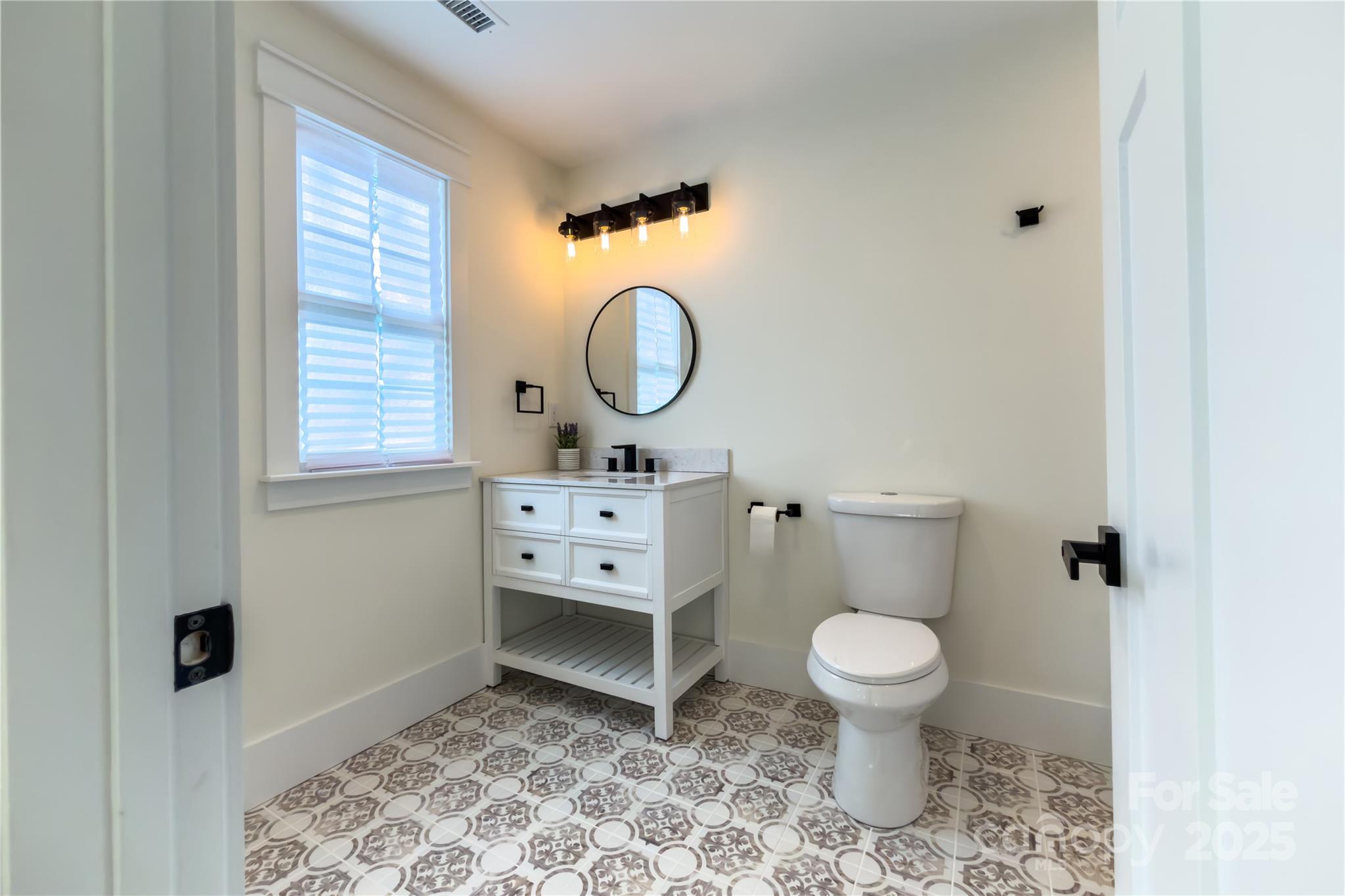 409 19th Ave Circle Northwest, Unit 12 Hickory, NC 28601 - Photo 39 of 46 a bathroom with a toilet sink and mirror