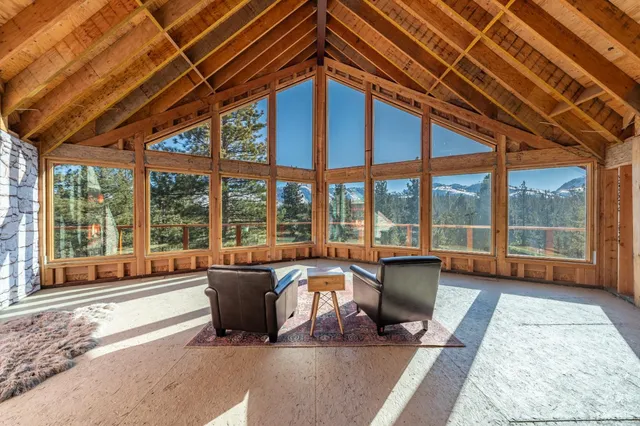 a living room with furniture and large windows