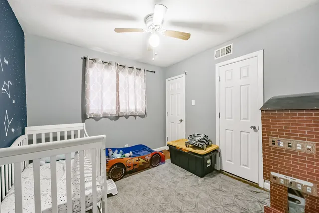 a view of a backyard with table and chairs and a large tree