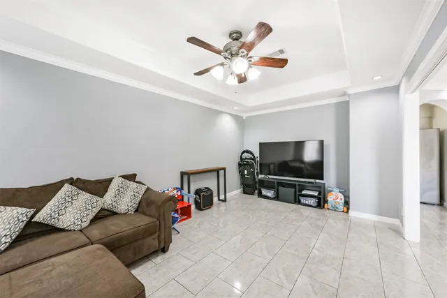 a living room with furniture and view of kitchen