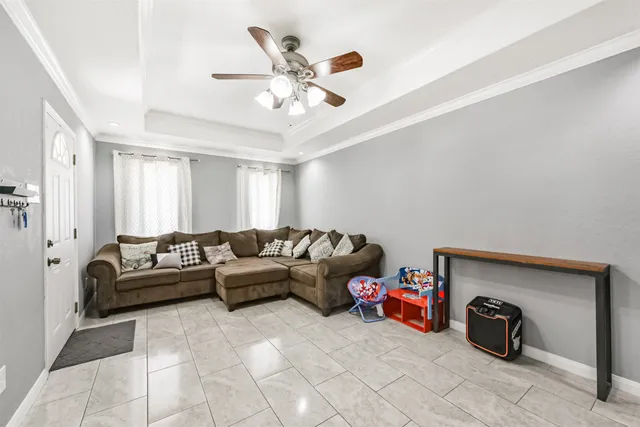 a view of a dining room with furniture and a chandelier fan