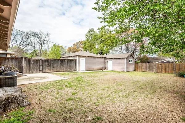a view of a yard with a house and garage