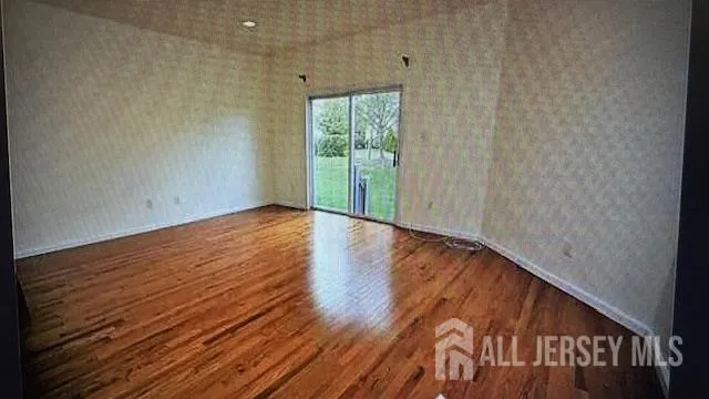 a view of a room with wooden floor and window