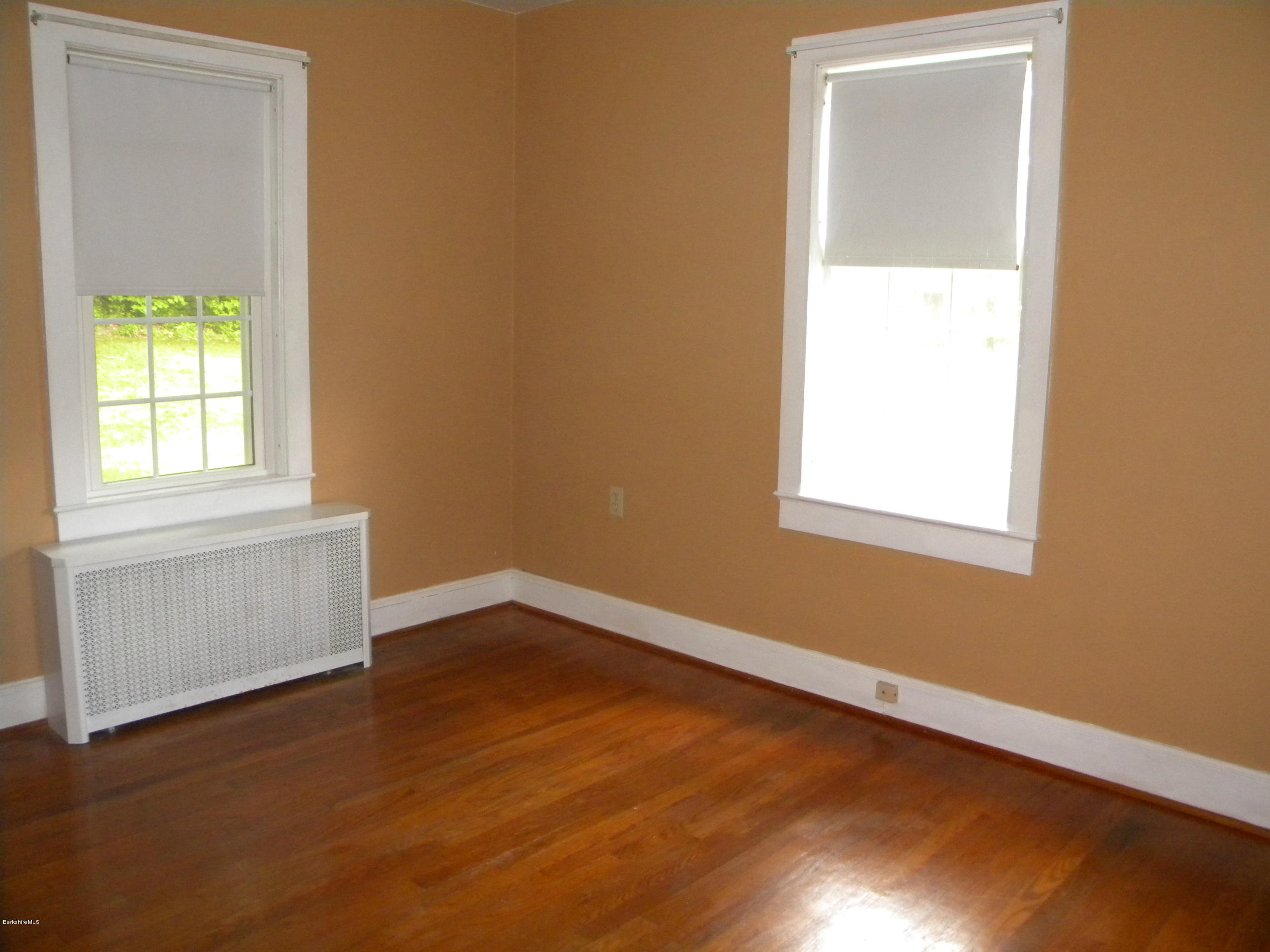 3 Whitcomb Hill Road Florida, MA 01343 - Photo 5 of 14 an empty room with wooden floor and windows