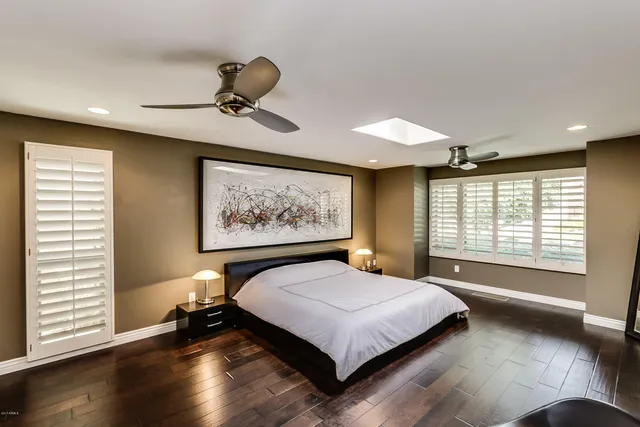 a bedroom with a bed and a large window