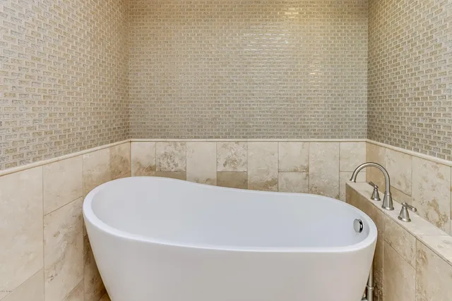 a white bath tub sitting in a bathroom