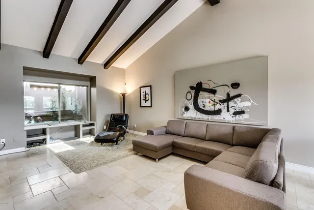 a living room with furniture and a floor to ceiling window