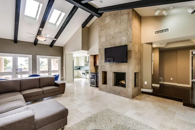 a living room with furniture a fireplace and a flat screen tv