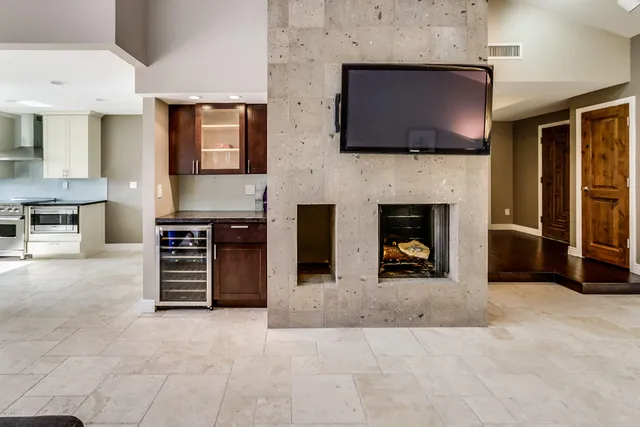 a living room with fireplace furniture and a flat screen tv