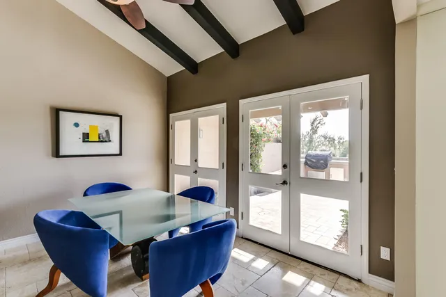 a dining room with furniture and window