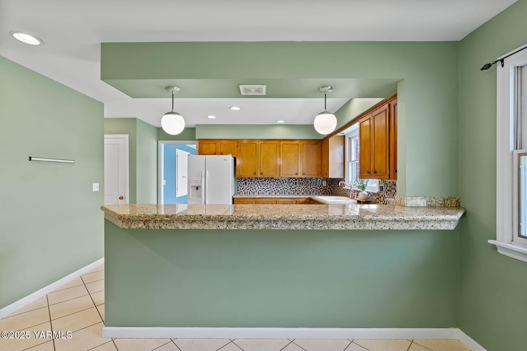 3609 Richey Road Yakima, WA 98902 - Photo 15 of 33 a view of a kitchen with kitchen island and living room