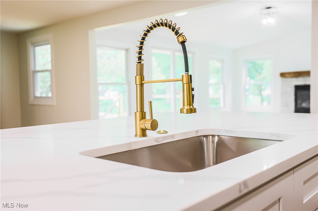 55 Elm Street Rittman, OH 44270 - Photo 17 of 46 Kitchen view of a sink, light countertops, and a fireplace