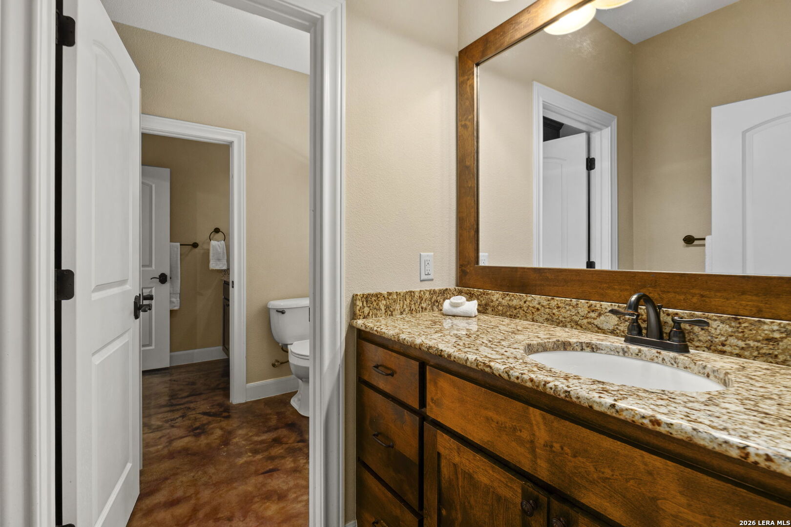 786 Shepherd's Crook Helotes, TX 78023 - Photo 23 of 36 a bathroom with a granite countertop sink and a mirror