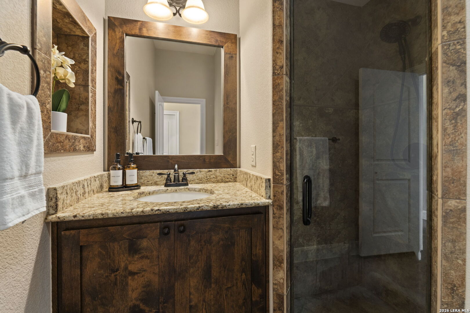 786 Shepherd's Crook Helotes, TX 78023 - Photo 25 of 36 a bathroom with a granite countertop sink and a mirror