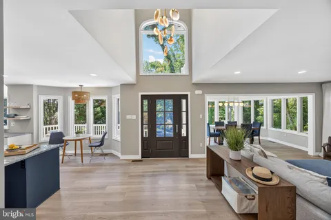 a kitchen with granite countertop a sink stove and cabinets