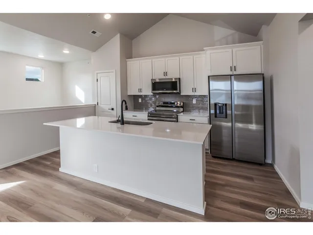 a kitchen with stainless steel appliances a refrigerator sink and microwave