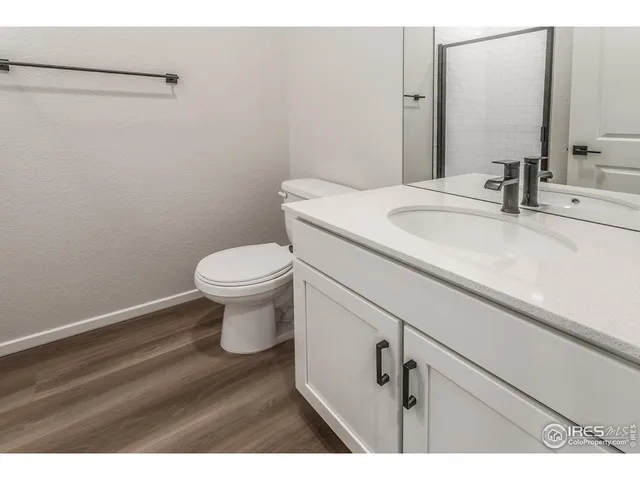 a bathroom with a sink toilet and a mirror