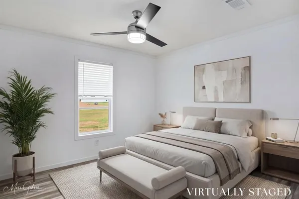 a bedroom with a bed and a window