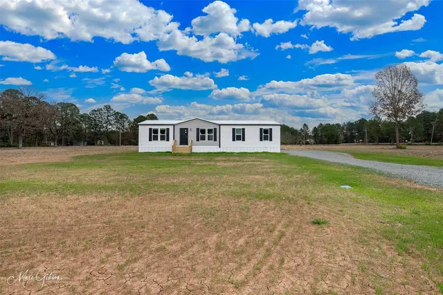 a view of a house with a big yard