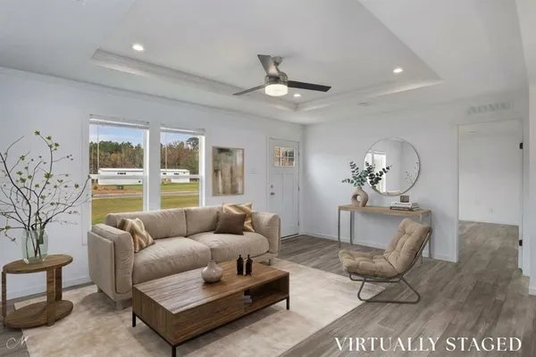 a living room with furniture potted plant and a large window
