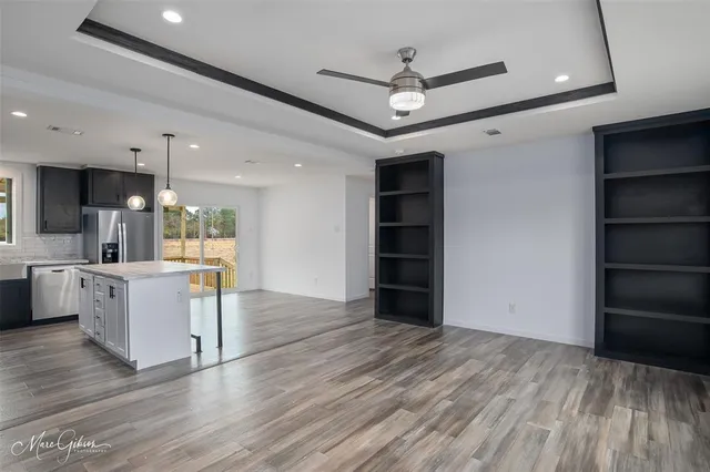 a view of kitchen with cabinets and wooden floor