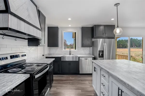 a kitchen with a sink stove and refrigerator