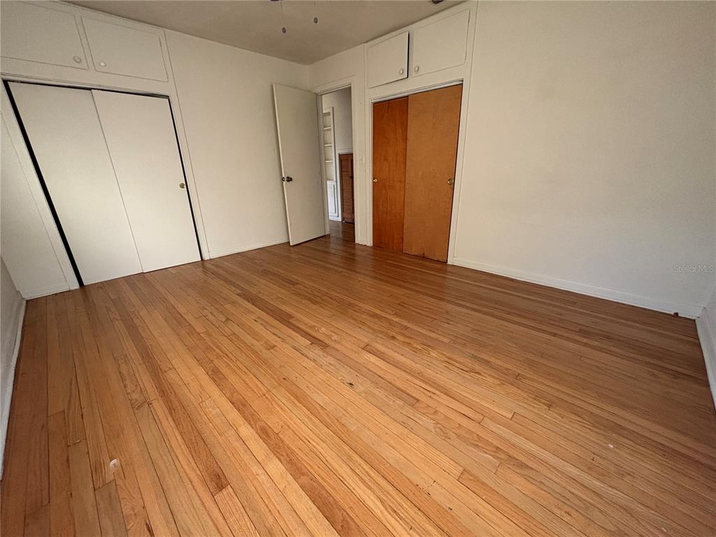 1102 Sunset Point Road, Unit 6 Clearwater, FL 33755 - Photo 14 of 31 a view of empty room with wooden floor