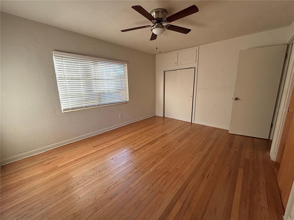 1102 Sunset Point Road, Unit 6 Clearwater, FL 33755 - Photo 15 of 31 a view of empty room with wooden floor and fan