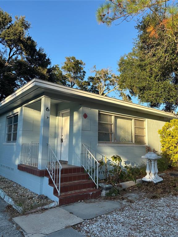 1102 Sunset Point Road, Unit 6 Clearwater, FL 33755 - Photo 2 of 31 a front view of a house with a yard
