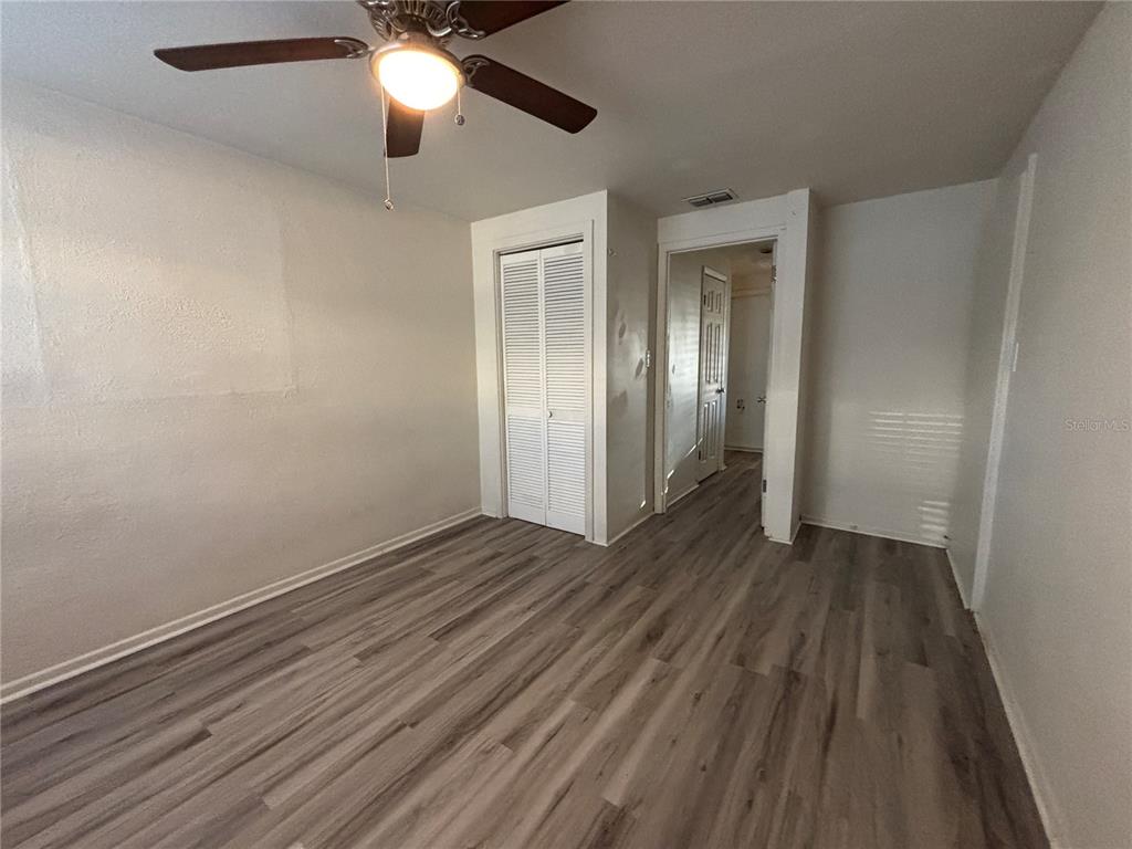 1102 Sunset Point Road, Unit 6 Clearwater, FL 33755 - Photo 24 of 31 a view of an empty room with wooden floor