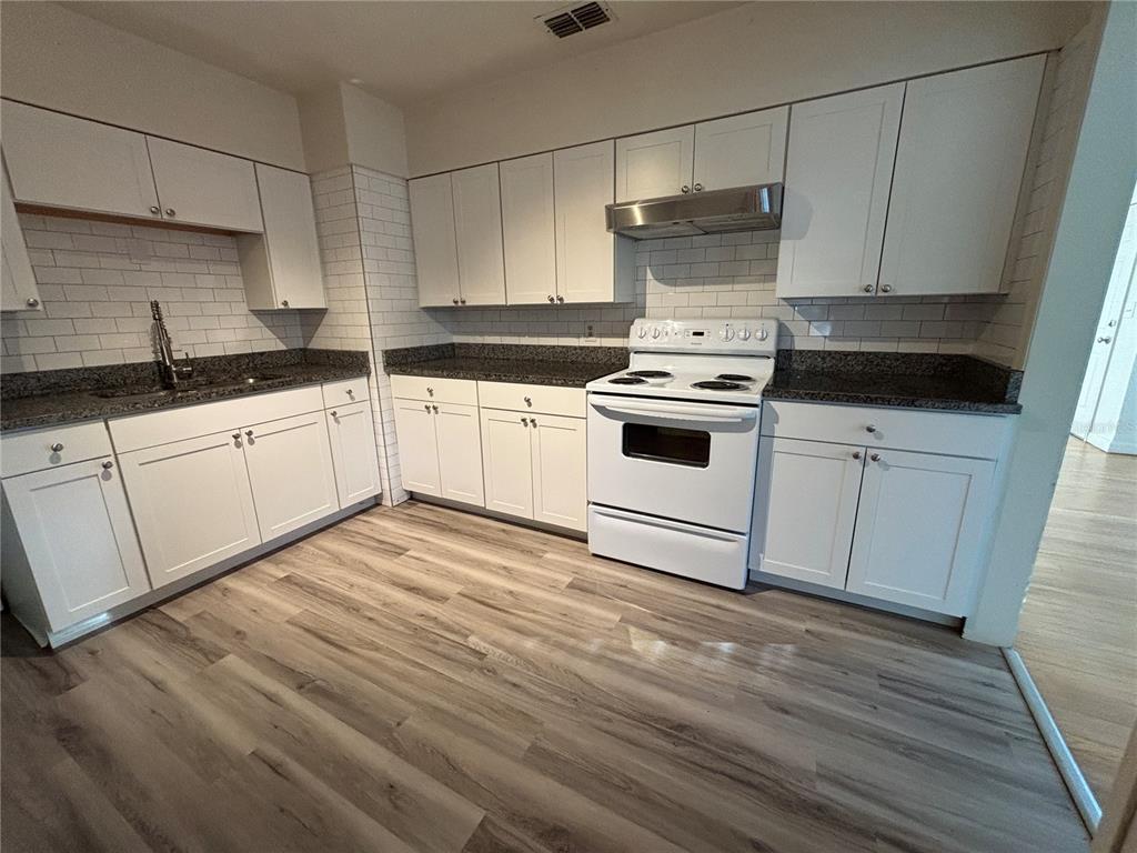 1102 Sunset Point Road, Unit 6 Clearwater, FL 33755 - Photo 7 of 31 a kitchen with a white cabinets and white appliances
