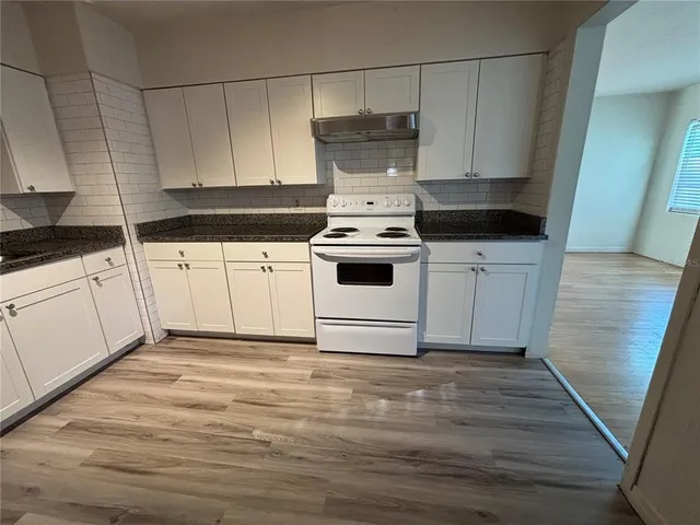 a kitchen with a white cabinets and white appliances